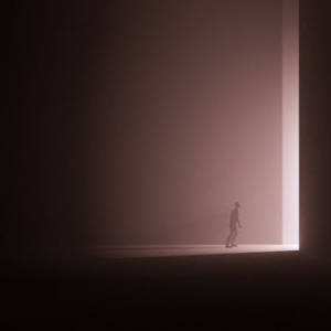 A silhouette walks through a bright doorway, creating a surreal and mysterious atmosphere.